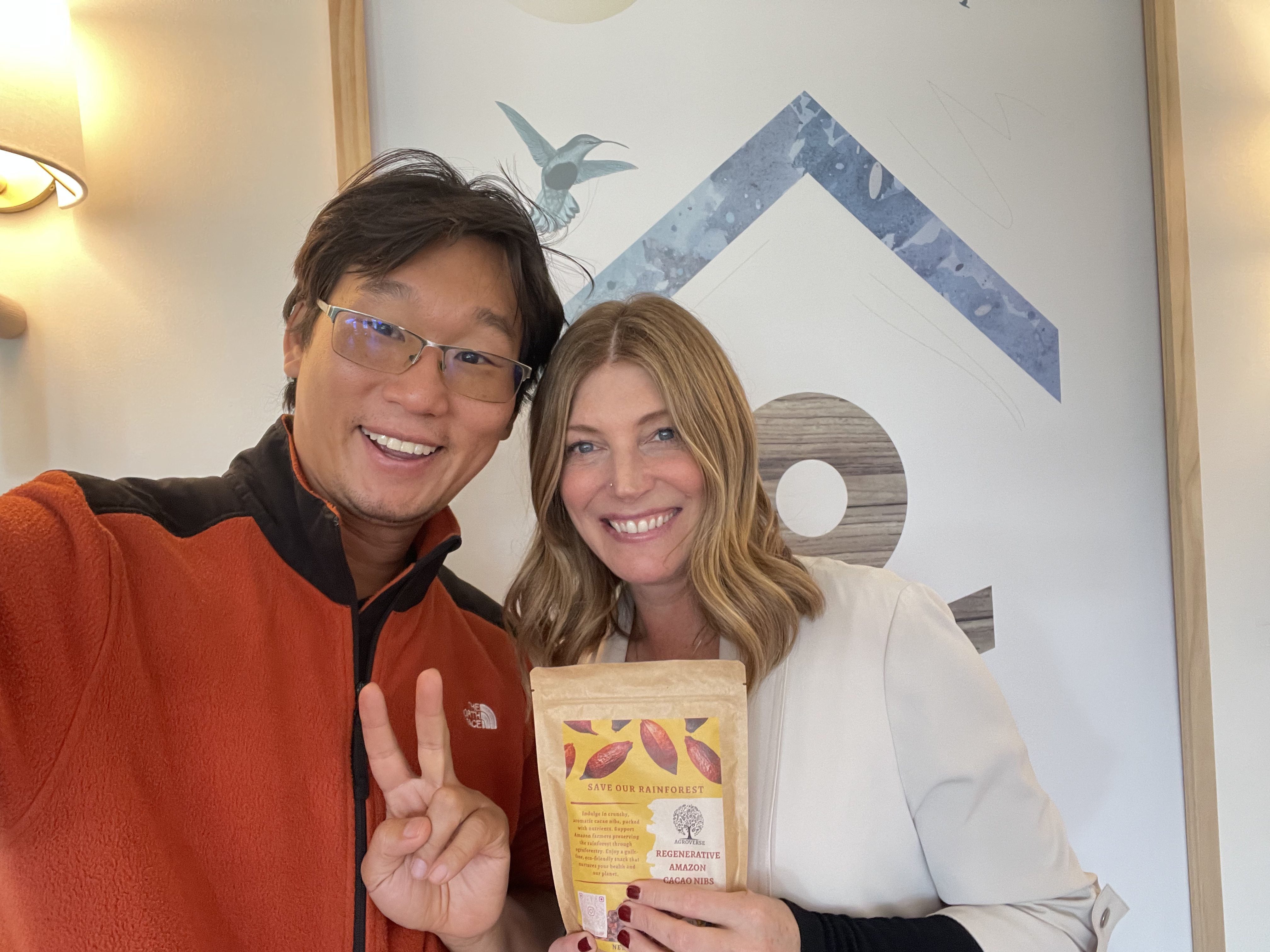 Trisha and partner holding Agroverse ceremonial cacao bags